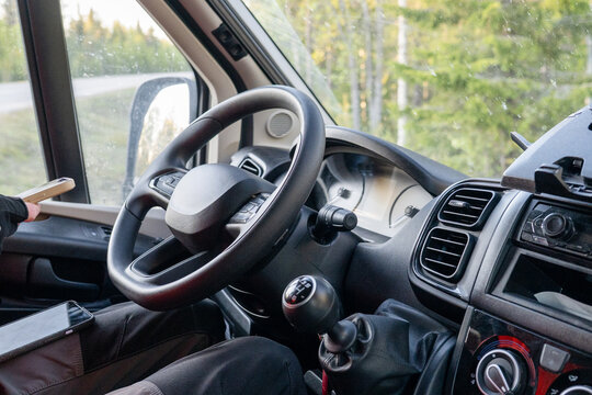 Driver cockpit of modern campervan parked in Finnish forest during summer road trip
