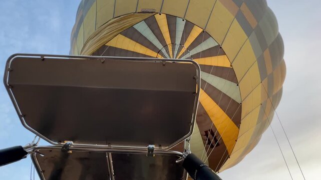 A hot air balloon is being inflated at dawn. Ideal for travel and adventure content.