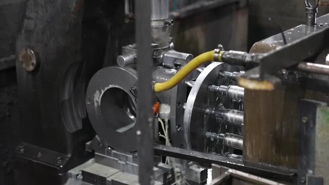 Cast iron valve body clamped in CNC rotary fixture during multi-axis machining operation