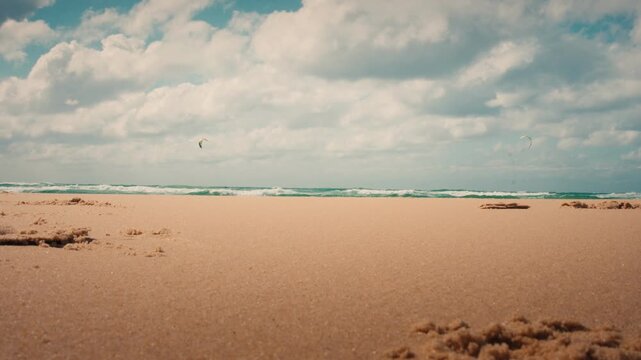 Plage de la Salie presents a vast and empty sandy landscape stretching towards the Atlantic Ocean. Wide eye-level view of the coastal wilderness under a soft blue sky and gentle light.