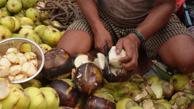 Vendor preparing fresh ice apple for sale