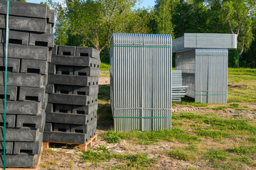 Fototapeta premium Temporary fencing panels and recycled plastic fence bases stored at construction site warehouse yard