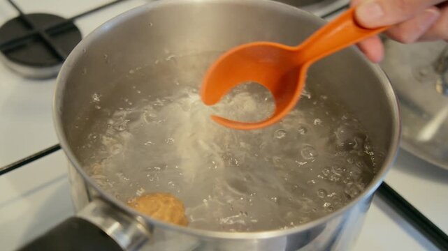 Eggs boiling in hot water during cooking process