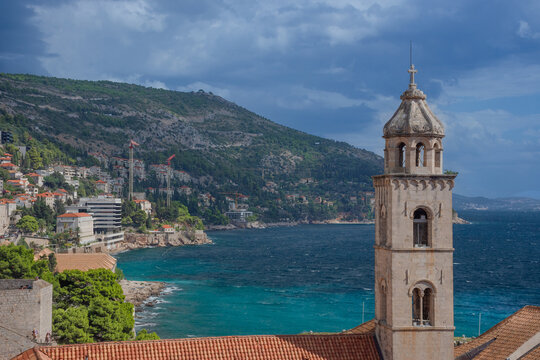 Dubrovnik Old Town with red terracotta roofs, the historic bell tower of the Dominican monastery and the harbor on the blue Adriatic Sea, in Croatia