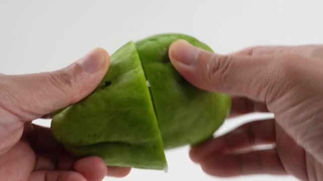 Chayote Halves Rubbed Together Releasing White Sap Isolated on White Background for Fresh Vegetable Preparation Concepts