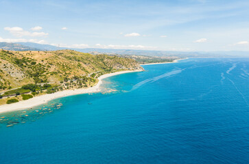 Fototapeta premium The Italian coast in Calabria with blue sea and clear waters aerial view
