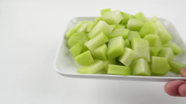 Sliced Chayote on Plate Picked Up and Put Back by Hand for Cooking Process Video
