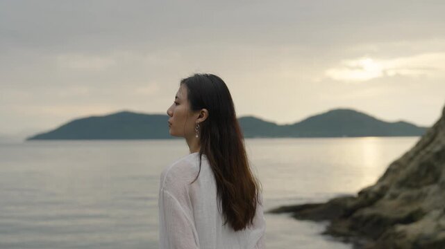 夕暮れの海にいる女性