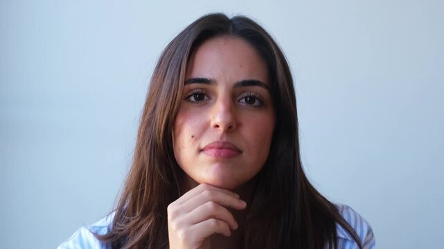 Confident young businesswoman looking at camera with professional expression in modern office