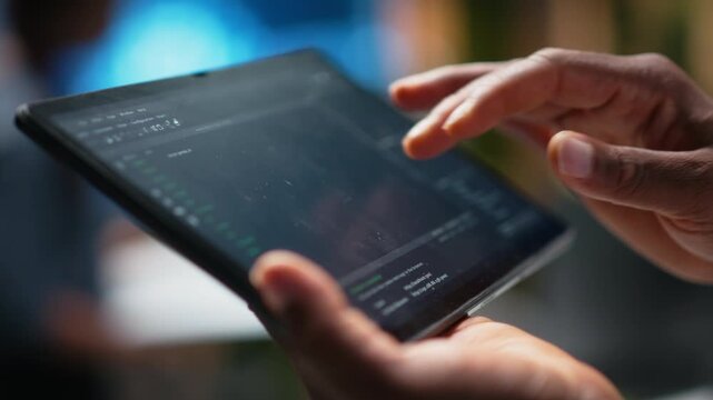 Close up of Silicon Valley company data scientist in office developing apps with device. Employee using deep learning tech on tablet at work to debug applications and resolve issues.