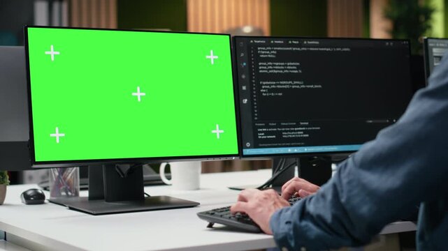 Green screen PC used by admin in office working to fix bugs in artificial intelligence system. IT specialist troubleshooting neural network errors in tech startup using chroma key computer.