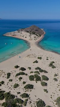 Experience the breathtaking views of Simos Beach, where golden sands meet turquoise waters on Elafonisos Island. Perfect for sunbathing, swimming, and exploring nature beauty. Elafonisos Island Greece
