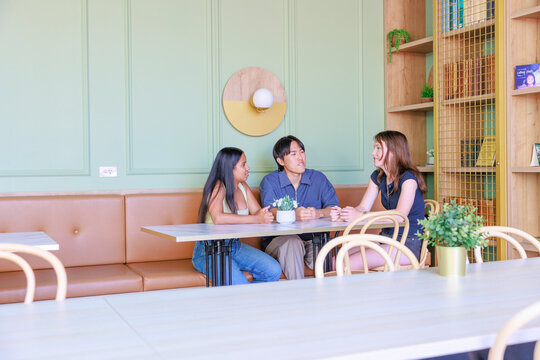 International University Students Chatting in a Cafe