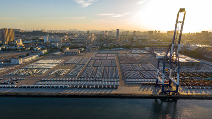 Port Container Yard and Urban Skyline at Sunrise © Zhaorui