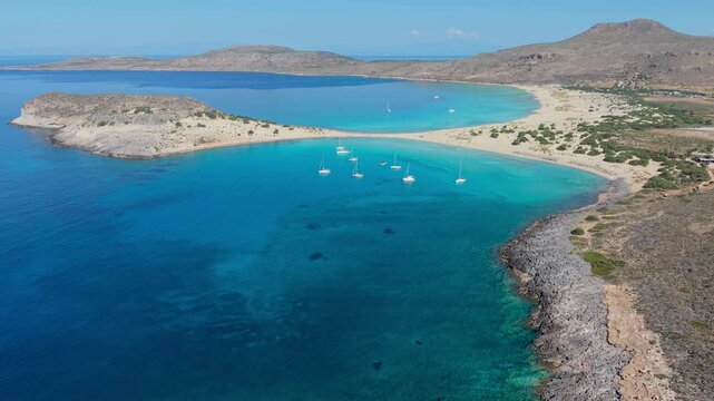 Simos Beach in Elafonisos captures paradise with its crystal-clear waters and sandy shores. Visitors enjoy sunbathing, swimming, and soaking up the tranquil atmosphere surrounded by natures beauty.