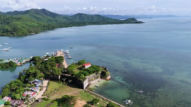 Aerial drone view of Fort Santa Isabel reveals the coral-stone Spanish fortress along Taytays tranquil coast, Philippines