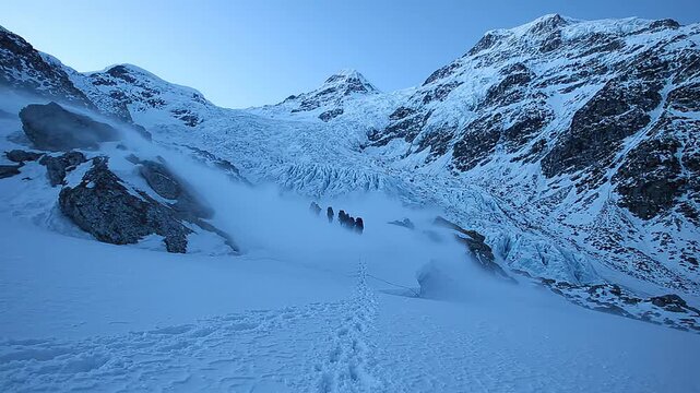 Alpine expedition with mountaineers undertaking glacier hiking and winter trekking, a challenging snow mountain adventure.
