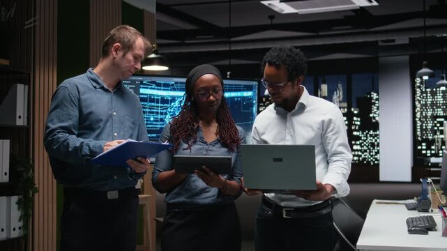 Engineering team in office developing machine learning algorithms simulating human brain thought processes. Teamworking colleagues deploy AI tools, performing software quality assurance.