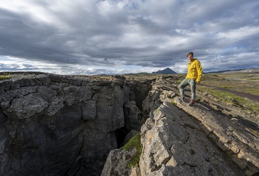Tourist at a crevice, Grj&oacute;tagj&aacute;, Myvatn, Iceland