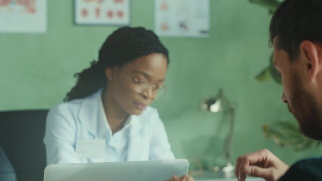 Doctor and patient exchanging serious looks, Healthcare professional and male patient involved in cautious interaction