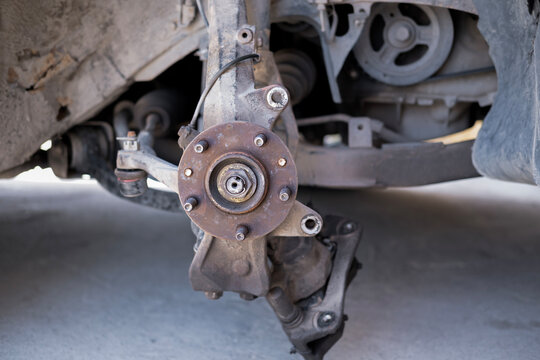 Close-up of a rusty car wheel hub assembly during brake repair