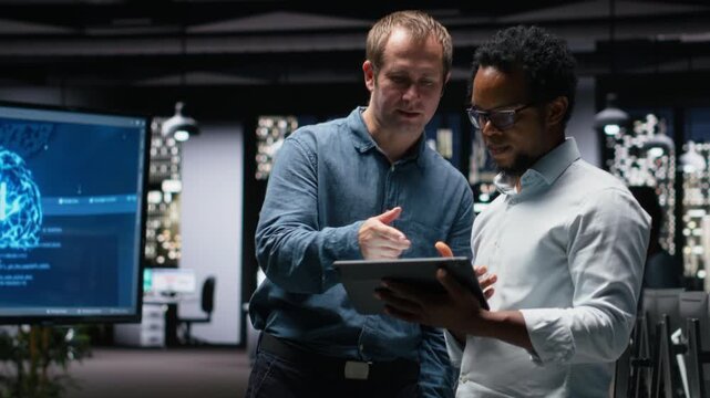 Programmers in office analyzing machine learning algorithms to prevent AI model errors. Colleagues reviewing code logic to improve artificial intelligence prediction accuracy for coding workflows.