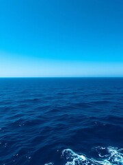 Obraz premium Vast ocean expanse under a clear sky, deep blue hues stretching to the horizon, ocean, sapphire
