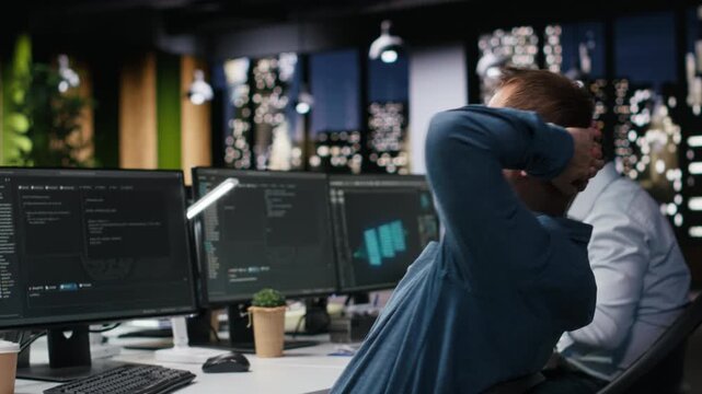 Stressed developer waiting anxiously at desk for positive result of code execution test with computer workflow for AI development workflow.