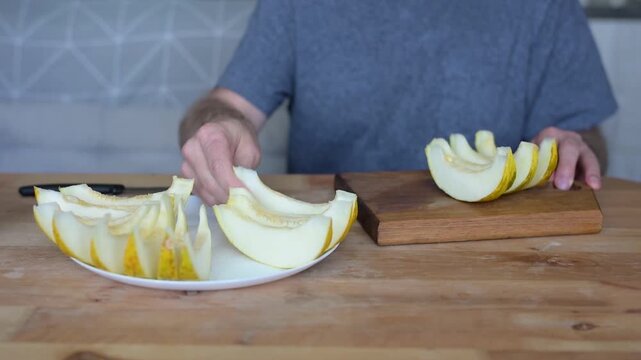 Man creating decorative cuts in melon wedge for elegant fruit video Full HD serving