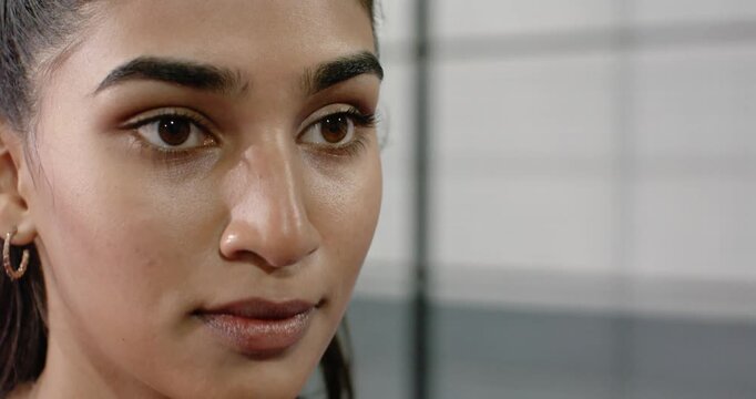 woman wearing black top on gym mat as camera opening tilting up