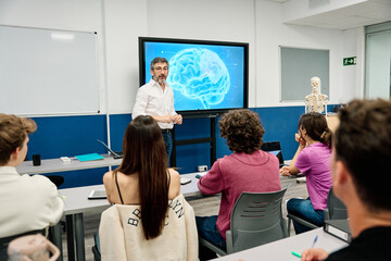 Professor teaching neuroscience to students in university classroom © alvaro