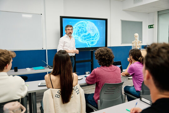 Professor teaching neuroscience to students in university classroom