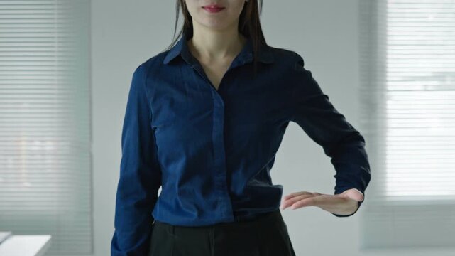 Business woman swiping a virtual interface from right to left with open palm gesture, suitable for digital navigation, technology mockup and UI concepts