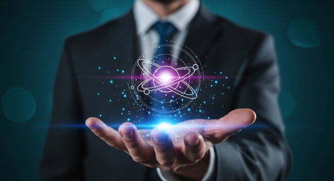 Businessman holding an atom graphic with orbiting electrons glowing light and particles