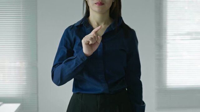 Professional business woman making a finger touch gesture on an invisible interface, perfect for technology mockups, app presentations, digital services and UI design