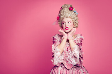 Photo of nervous lady princess in medieval antique style dress look empty space isolated pink color background © deagreez