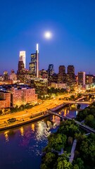 Fototapeta premium A nighttime cityscape with a river and bridge