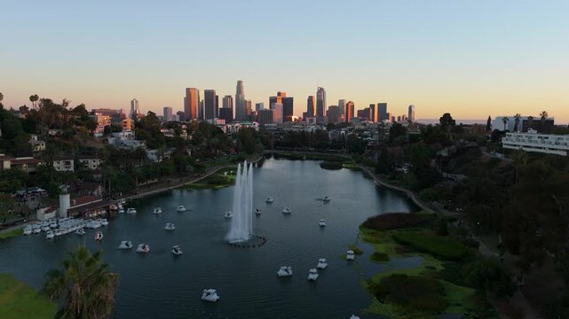 Echo Park Lake aerial pull back revealing downtown Los Angeles skyline at sunset, November 25, 2025
