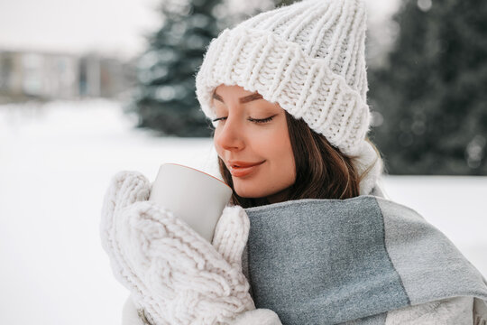 Ukrainian Woman Savoring Warm Drink During Peaceful Winter Retreat Outdoors