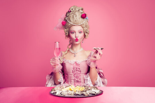 Photo of beautiful princess british lady drinking tea english breakfast isolated on pink color background