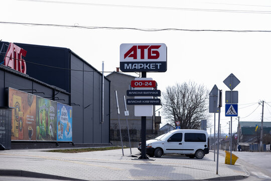 Horodok, Ukraine - March 23, 2026: ATB Market store signage stands near a grocery building with parking, indicating retail services in an urban commercial district street setting