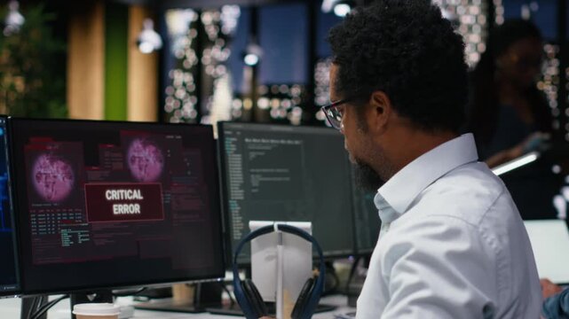 Engineer in office receiving critical error warning while writing code. worker in Silicon Valley startup using PC to troubleshoot software glitches, resolving system crashes for coding workflows.