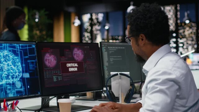 Panicked admin at office desk thinking how to fix critical error alert displayed on PC screen with debugging and troubleshooting context.