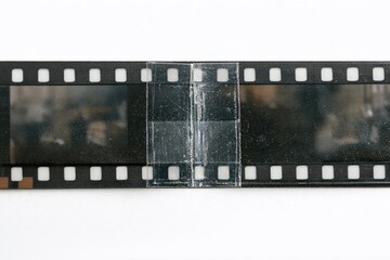 Fototapeta premium A close-up shot of a film strip lying on a white surface, perfect for photography or film-related uses