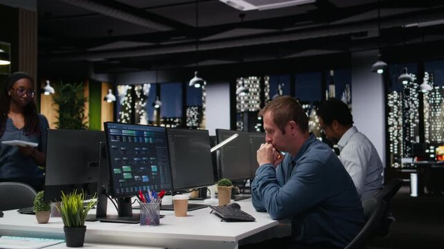 Stressed man in company workplace worried by glitches while doing artificial intelligence tech quality assurance. Anxious admin in office struggling with AI programming languages script.