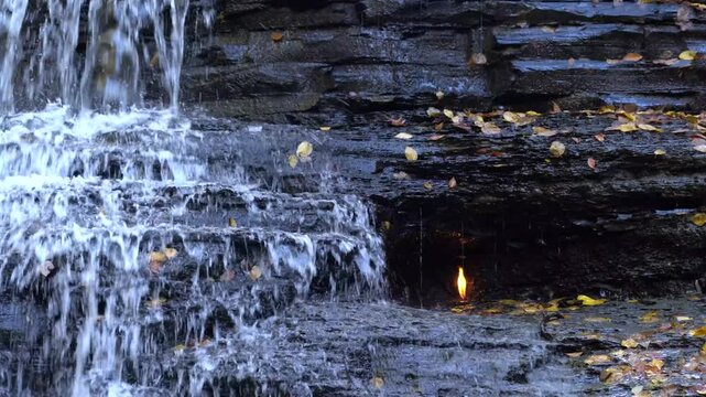 Medium shot of flame and waterfall found at Eternal Flame Falls near Buffalo, New York in the autumn.