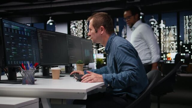 System administrator in company workplace doing artificial intelligence tech quality assurance. Man in office typing on keyboard, writing AI script with programming languages for coding workflows.