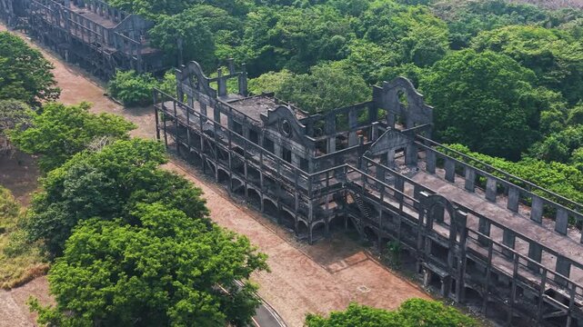 Cinematic aerial sweep over the historic Mile Long Barracks ruins on Corregidor Island. A hauntingly beautiful look at World War II history reclaimed by nature in the Philippines.