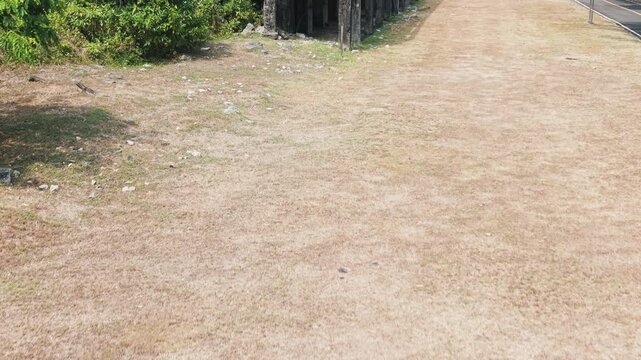 Cinematic aerial shot revealing the historic bombedout barracks on Corregidor Island. This significant World War II landmark showcases weathered concrete structures and lush tropical greenery.
