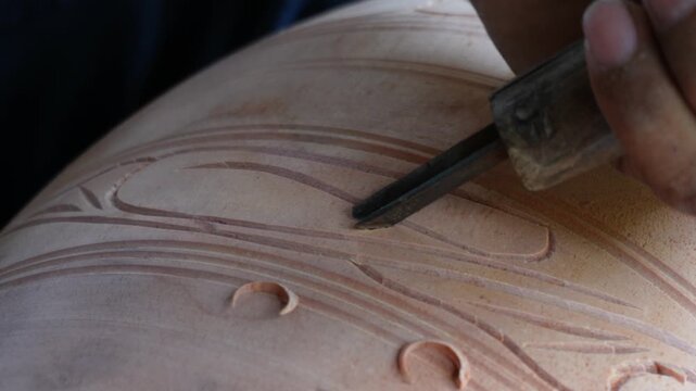 Wood carving tool crafting intricate wooden patterns